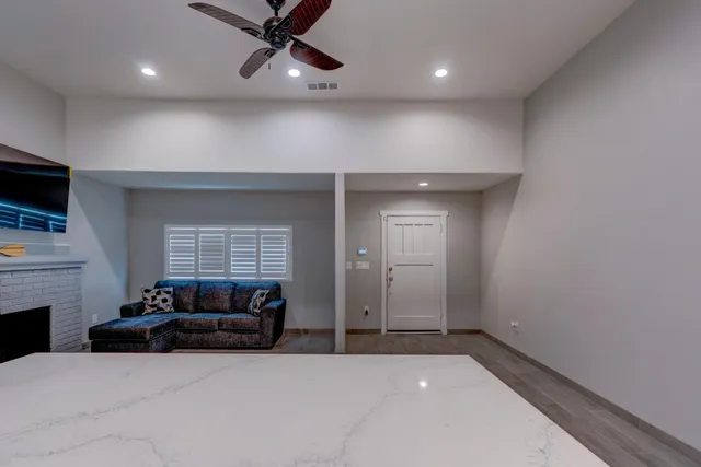 a view of a livingroom with furniture and a ceiling fan