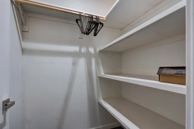 a bathroom with a granite countertop sink toilet a mirror and shower