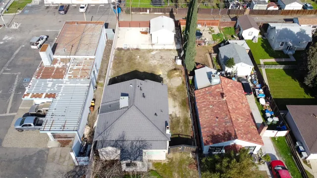 an aerial view of a houses with yard
