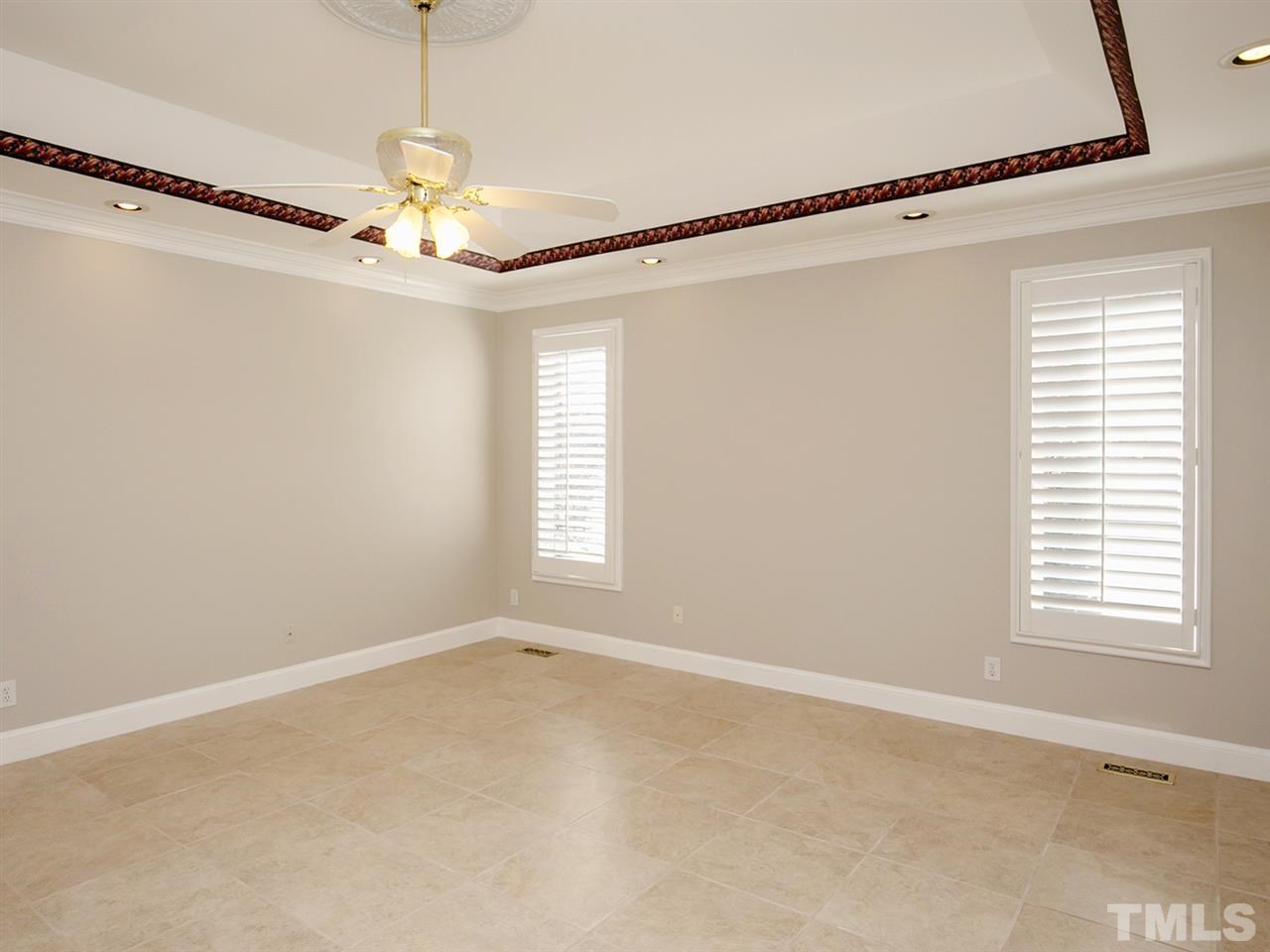 7701 Rainwater Road Raleigh, NC 27615 - Photo 22 of 25 a view of a big room with windows and chandelier fan
