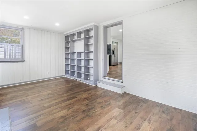 an empty room with windows and a fireplace