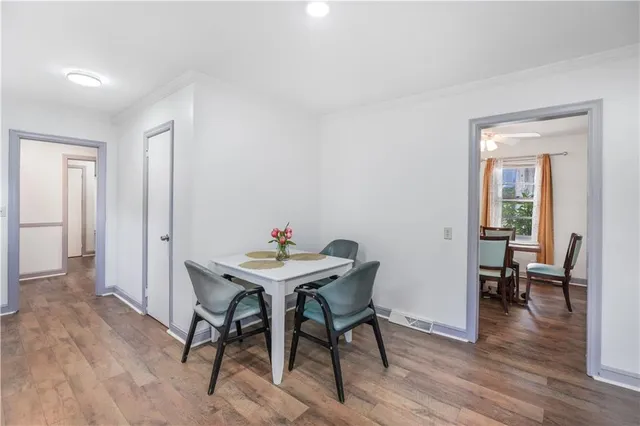 a kitchen with a table chairs refrigerator and microwave