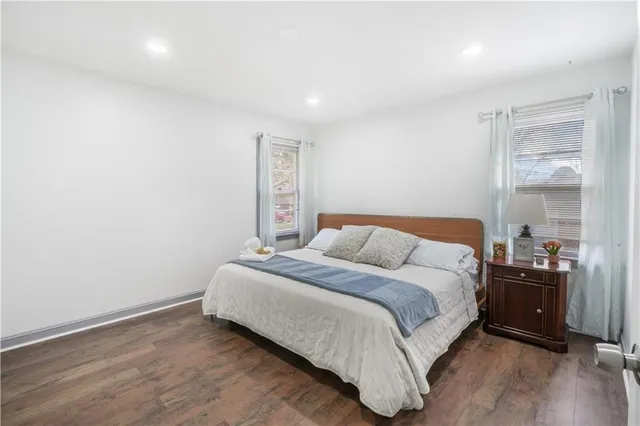 a bedroom with a bed and a night stand