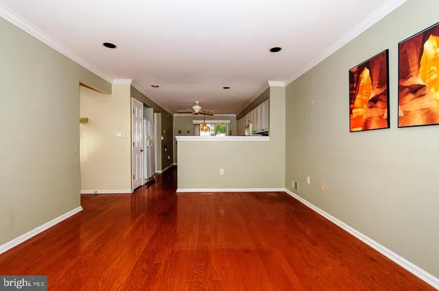 a view of a room with wooden floor and window