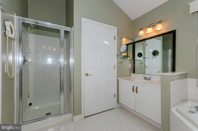a bathroom with a shower sink and mirror