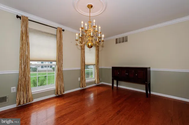 a view of a room with wooden floor and large window