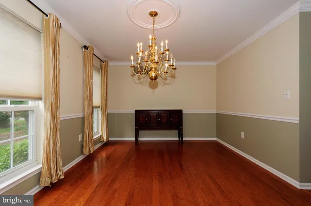 a view of a room with wooden floor and staircase
