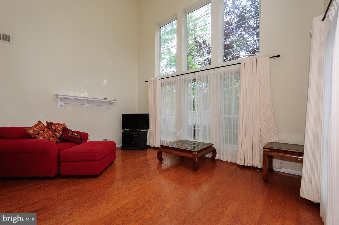 109 Deer Run Court Pennington, NJ 08534 - Photo 7 of 25 a living room with furniture a flat screen tv and a window