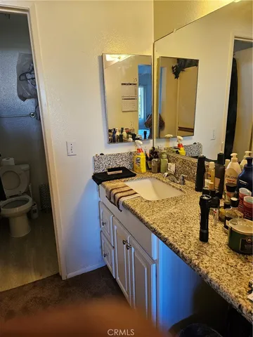 a bathroom with sink granite and a mirror