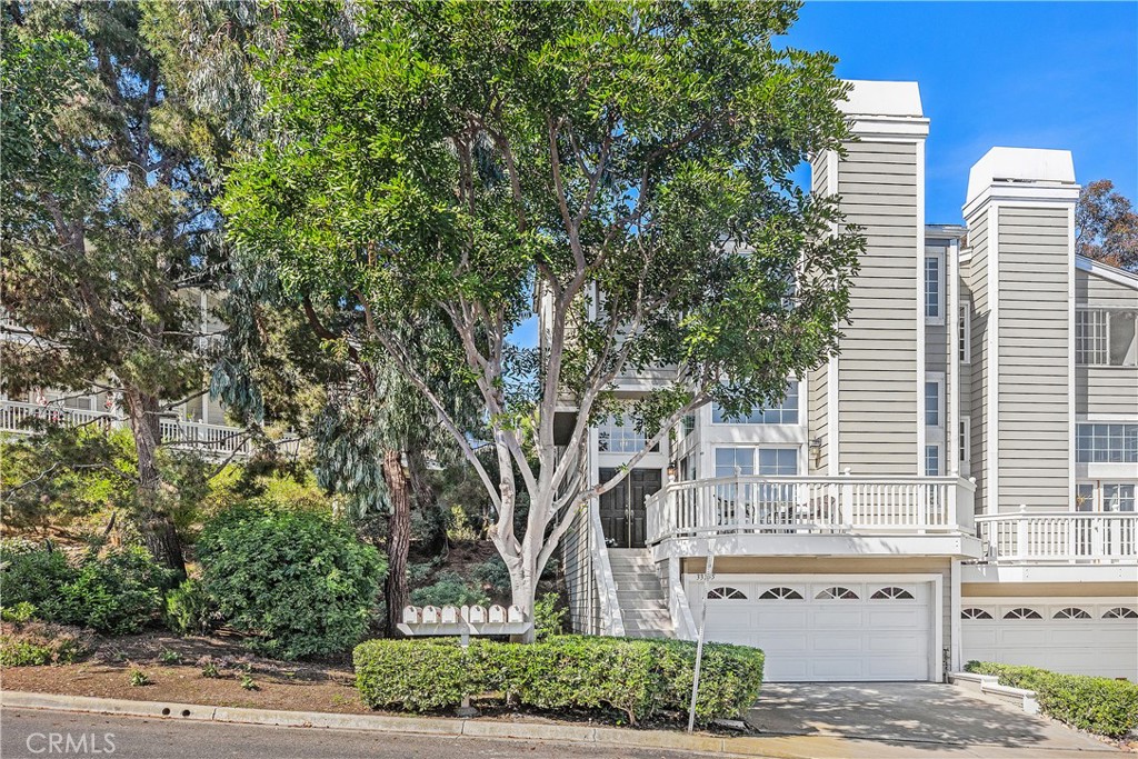 33255 Ocean Ridge, Unit 30 Dana Point, CA 92629 - Photo 1 of 1 a front view of a house with a garden