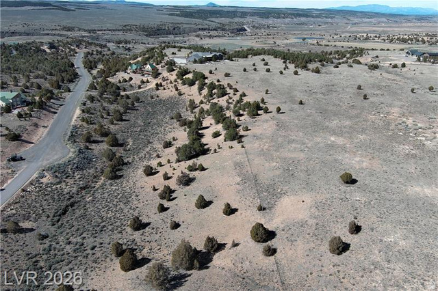 1825 Eagle Ridge Circle, Unit 15 Hatch, UT 84735 - Photo 6 of 33 Aerial view of sparsely populated area with a desert landscape and a mountainous background
