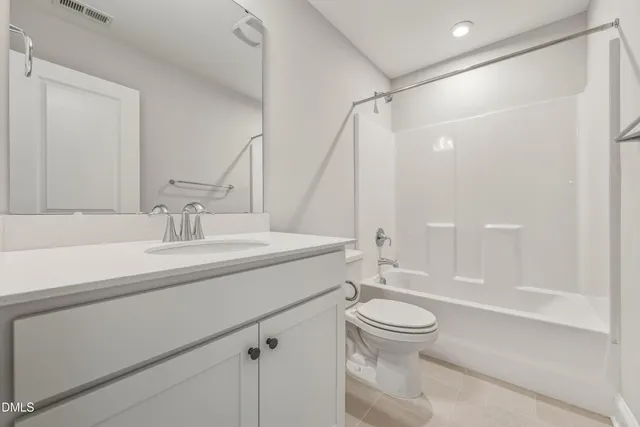 a bathroom with a sink a toilet and a large mirror