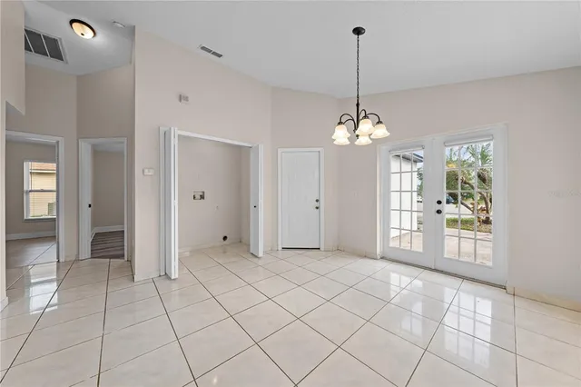 a view of a room with window and chandelier
