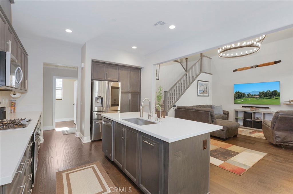 a open kitchen with stainless steel appliances granite countertop a lot of counter space and wooden floor