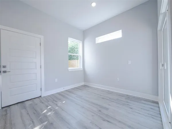 a kitchen with stainless steel appliances granite countertop a sink and a stove top oven with wooden floor