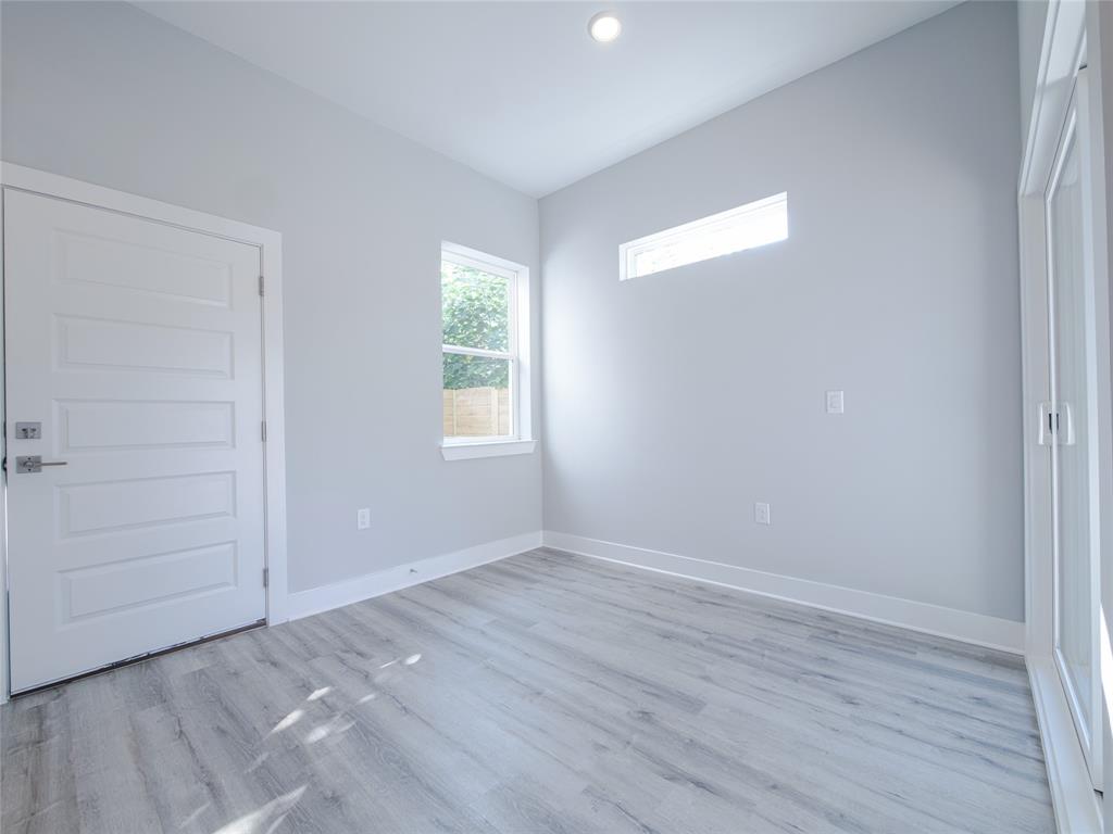 1042 Rosemont Street, Unit 1 Austin, TX 78723 - Photo 10 of 31 wooden floor in an empty room with a window