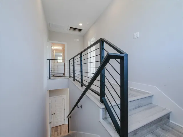 a view of a hallway with wooden floor and entryway