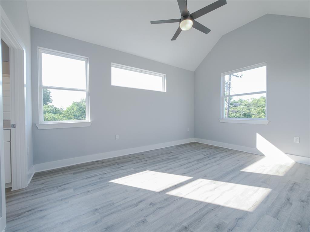 1042 Rosemont Street, Unit 1 Austin, TX 78723 - Photo 15 of 31 an empty room with wooden floor and windows