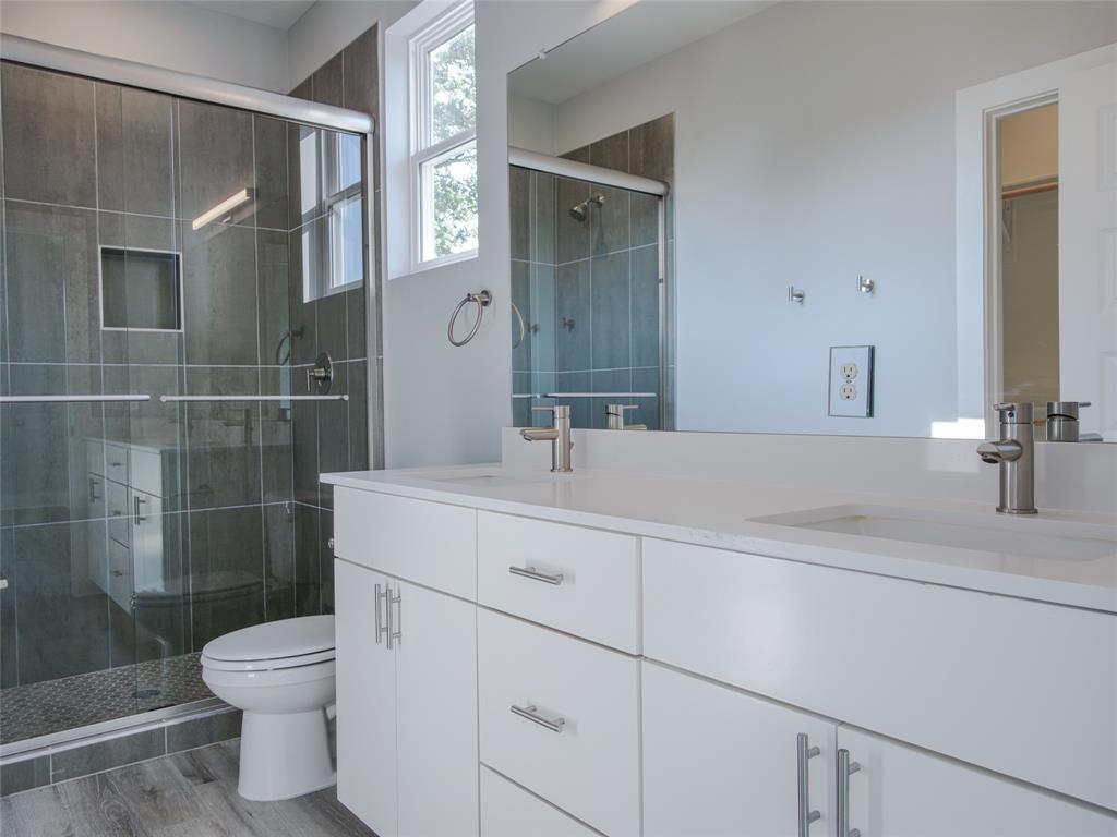 1042 Rosemont Street, Unit 1 Austin, TX 78723 - Photo 17 of 31 a bathroom with a sink a toilet and shower