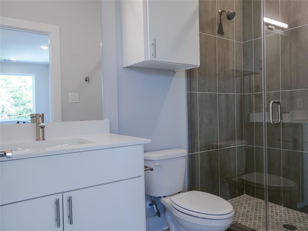 1042 Rosemont Street, Unit 1 Austin, TX 78723 - Photo 19 of 31 a bathroom with a sink a toilet and shower