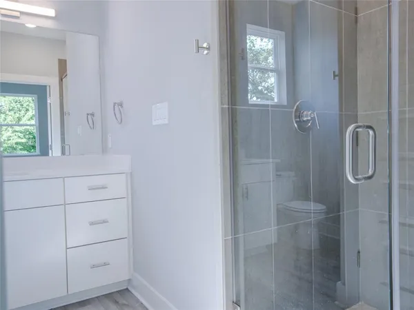 a view of empty room with wooden floor