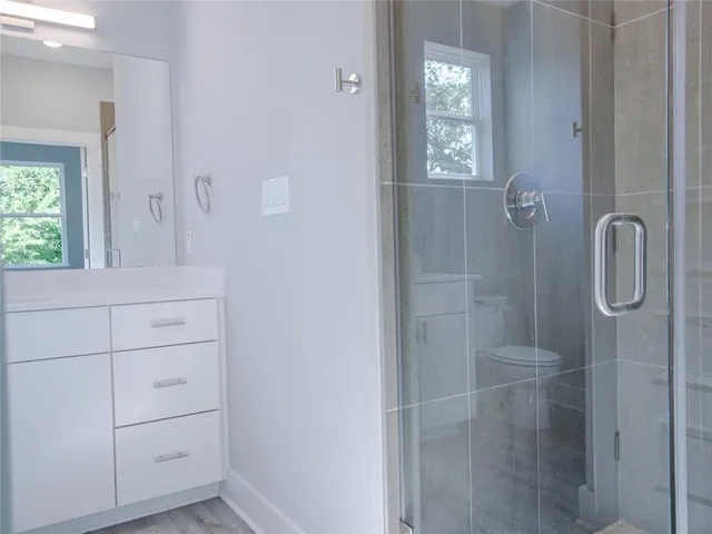 a view of empty room with wooden floor