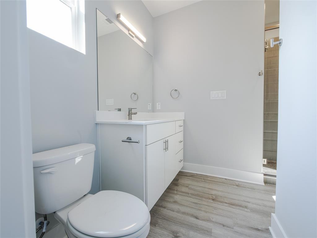 1042 Rosemont Street, Unit 1 Austin, TX 78723 - Photo 28 of 31 a bathroom with a toilet a sink and wooden floor