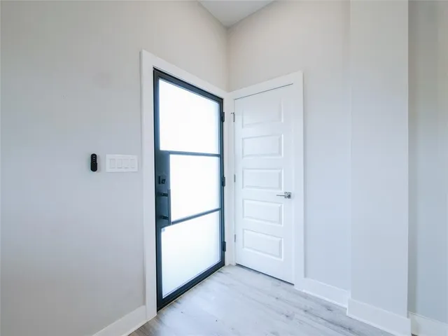 a view of empty room with closet and window