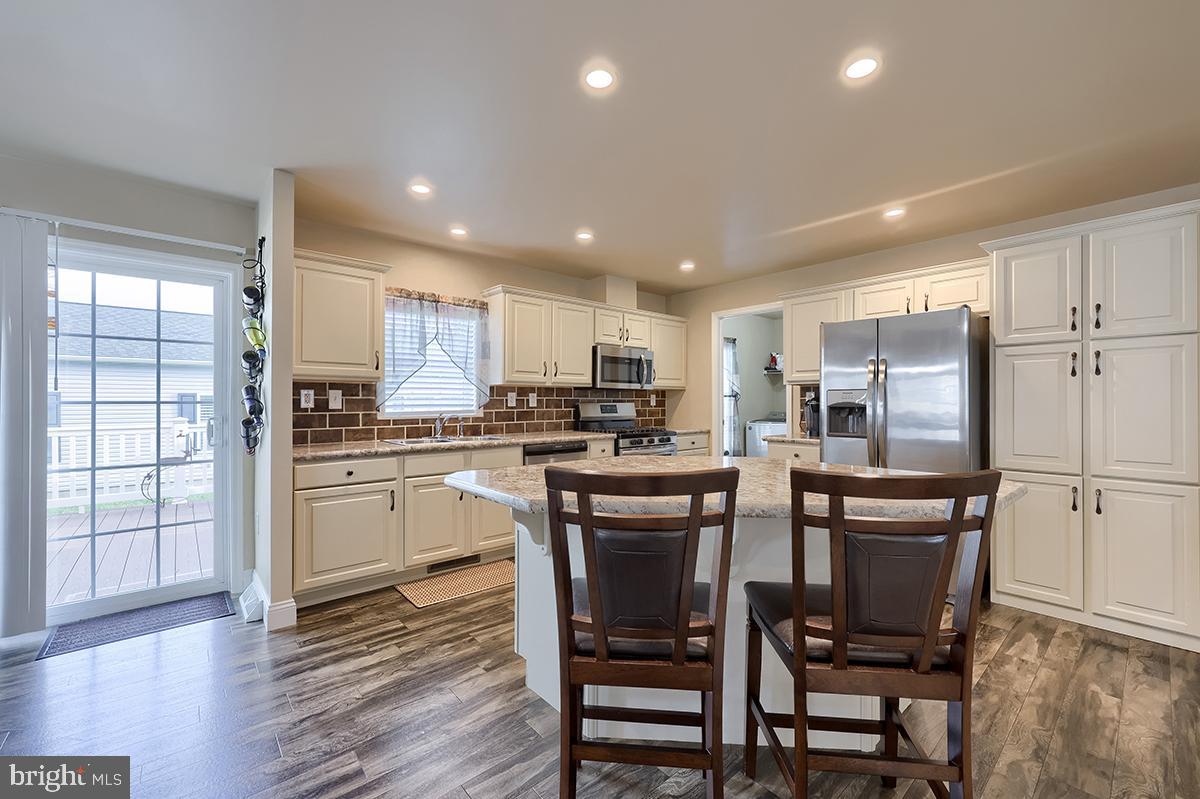 39 Westin Road Douglassville, PA 19518 - Photo 15 of 37 a kitchen with refrigerator a stove and chairs