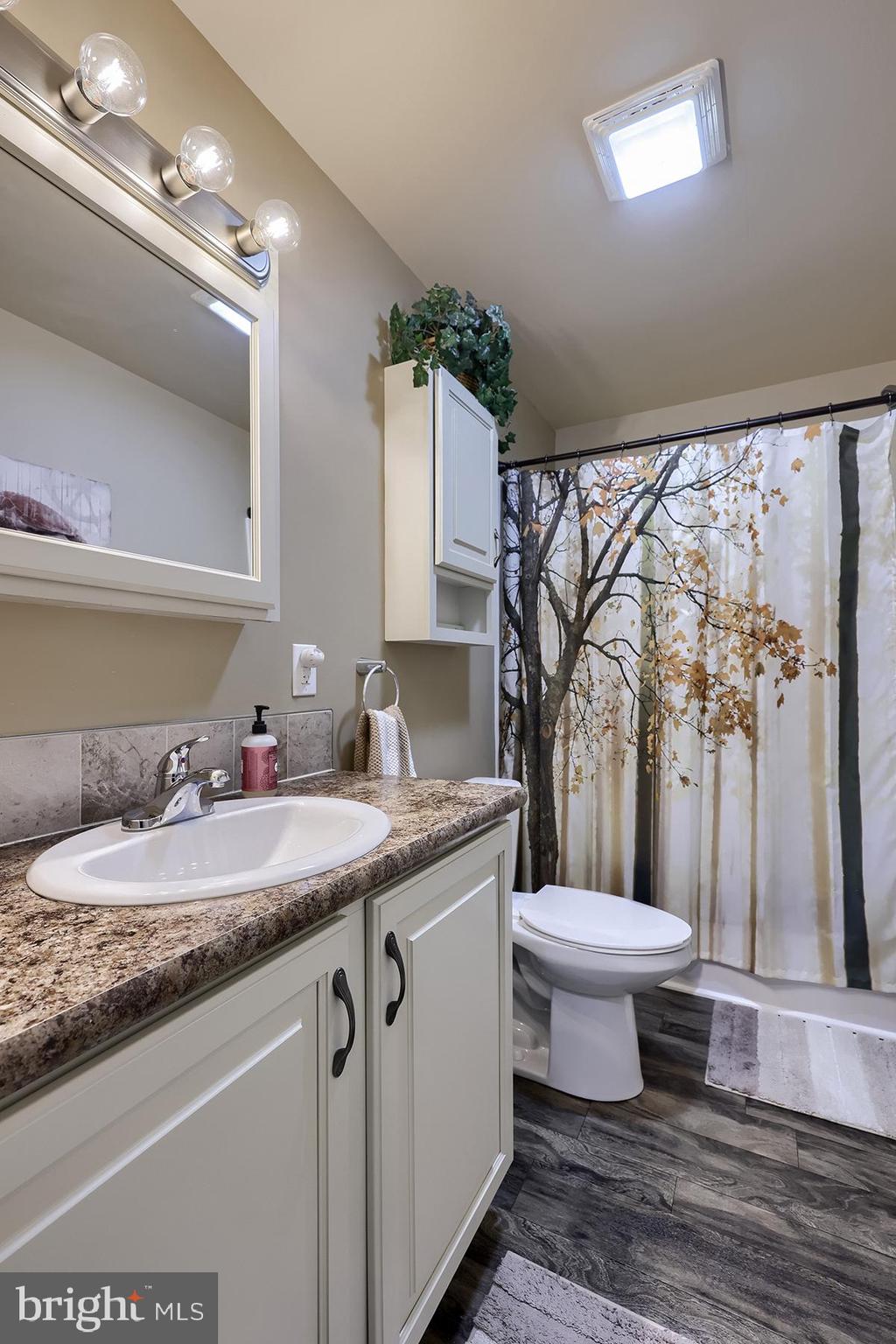 39 Westin Road Douglassville, PA 19518 - Photo 22 of 37 a bathroom with a granite countertop sink toilet and a mirror