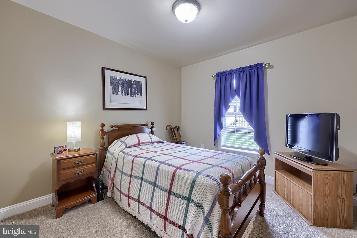 39 Westin Road Douglassville, PA 19518 - Photo 24 of 37 a bedroom with a bed and a flat screen tv