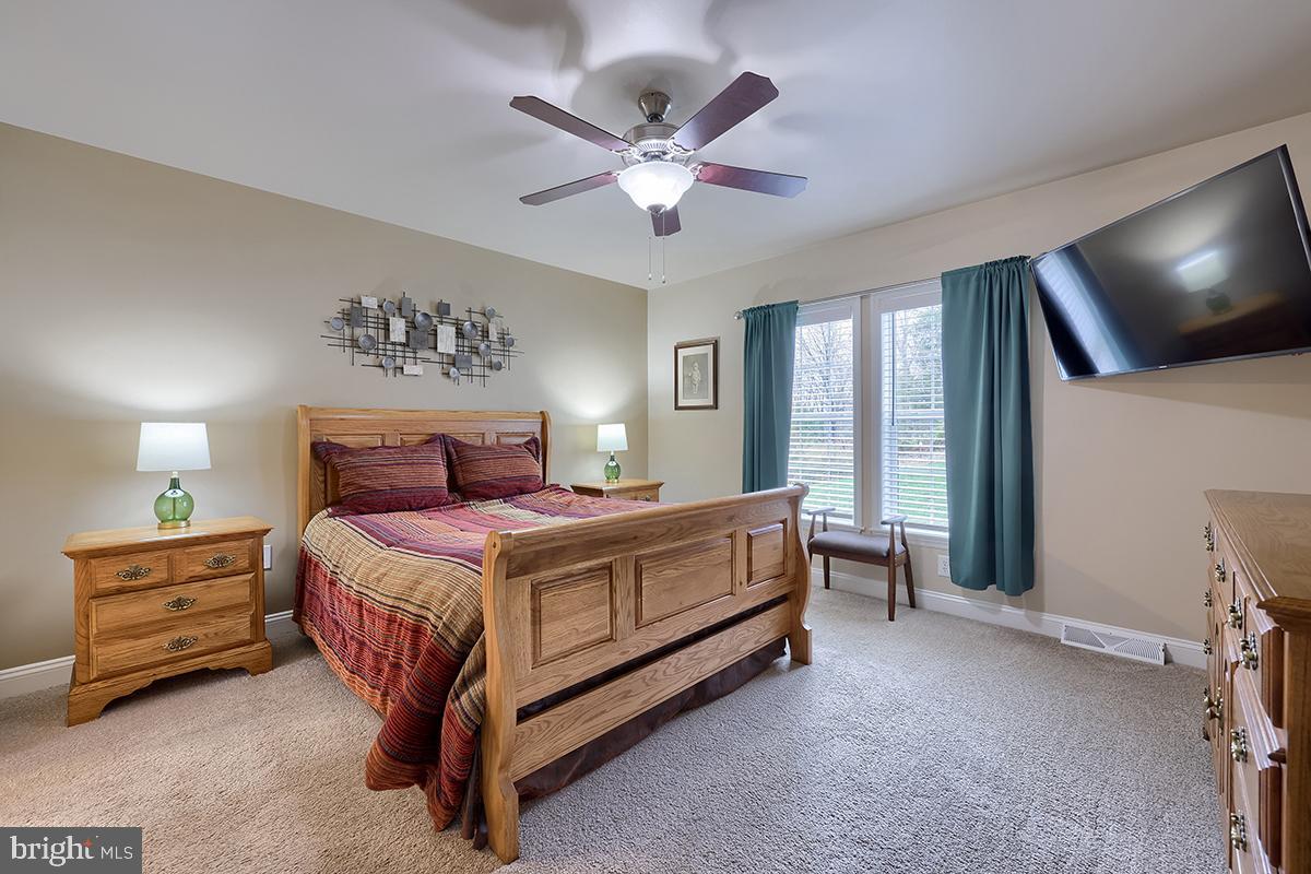 39 Westin Road Douglassville, PA 19518 - Photo 25 of 37 a spacious bedroom with a bed and a flat screen tv