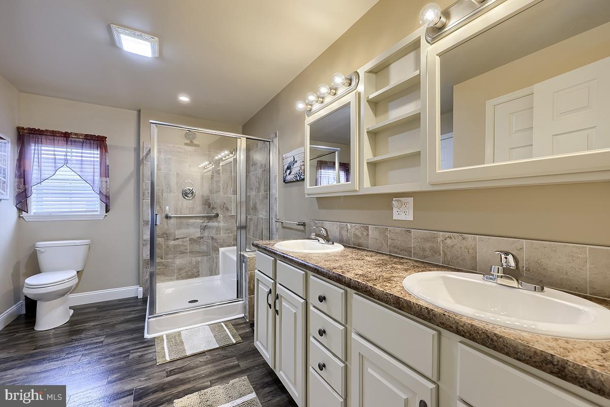 39 Westin Road Douglassville, PA 19518 - Photo 27 of 37 a spacious bathroom with a granite countertop sink toilet and shower
