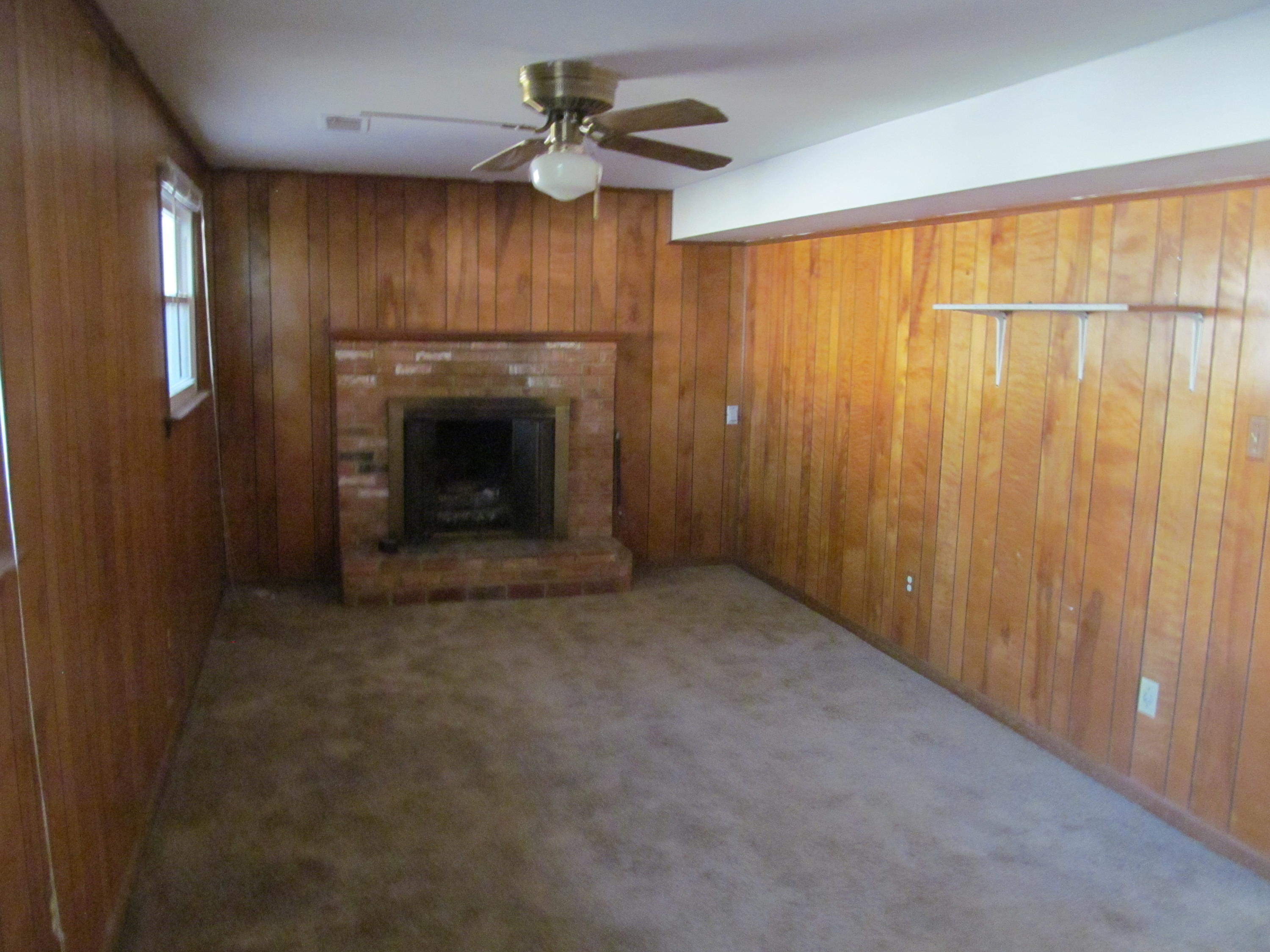 624 Ramada Road Vinton, VA 24179 - Photo 14 of 25 a view of an empty room with a fireplace and a window