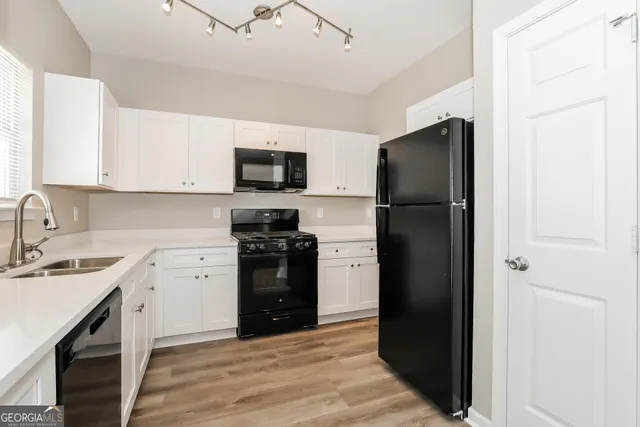a kitchen with a refrigerator stove and sink