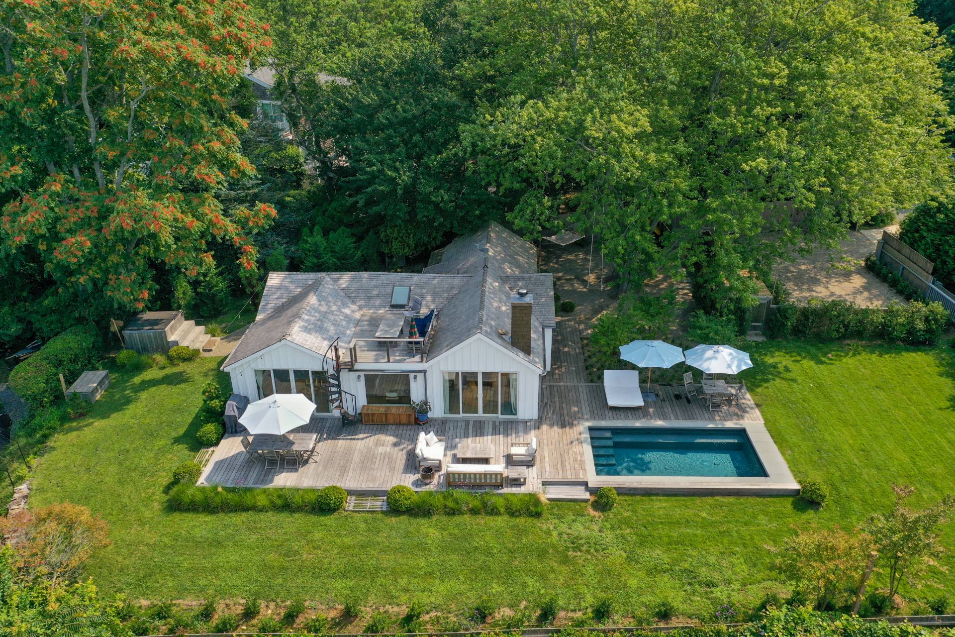 a front view of a house with a yard table and chairs