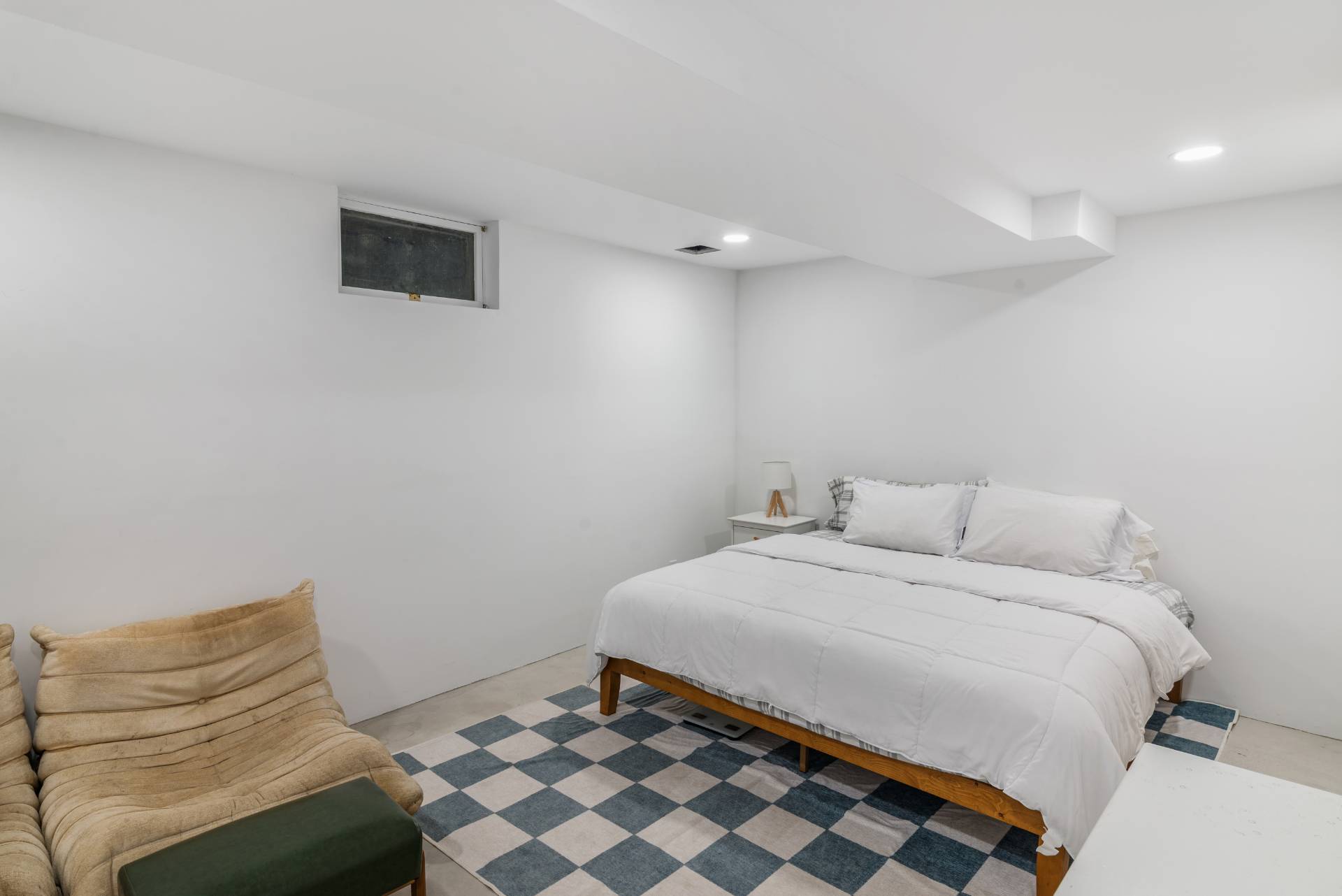 58 Fleming Road Montauk, NY 11954 - Photo 22 of 35 a bedroom with a bed and a chair