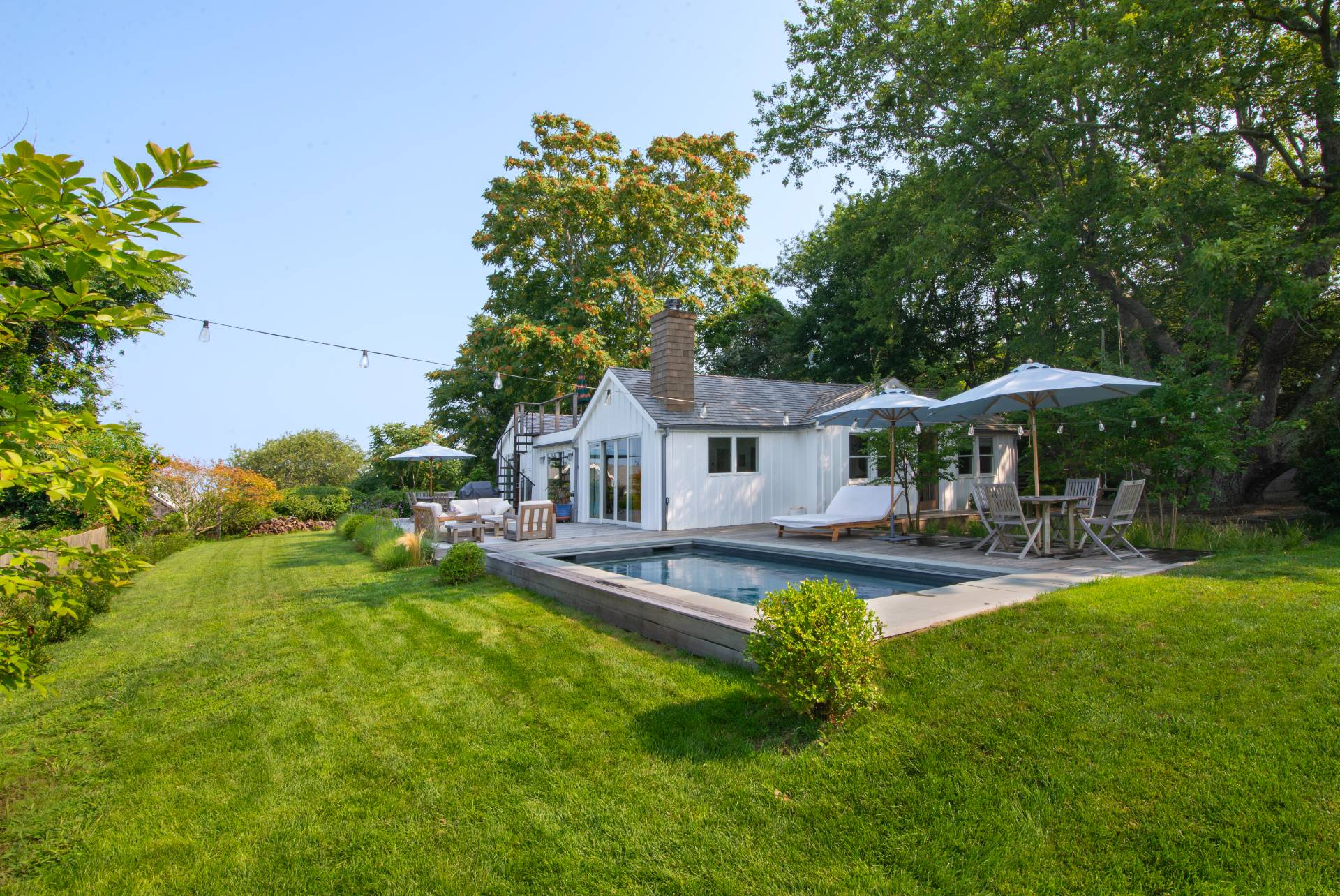 58 Fleming Road Montauk, NY 11954 - Photo 25 of 35 a front view of a house with swimming pool having outdoor seating