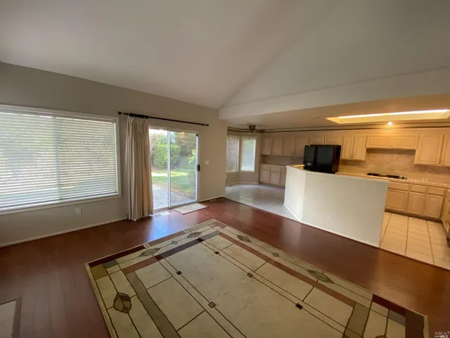 a view of a kitchen with a sink and wooden floor