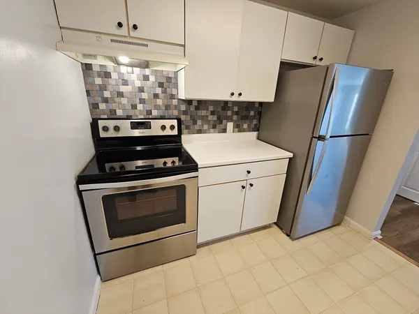 a kitchen with stainless steel appliances wooden cabinets and a counter top space