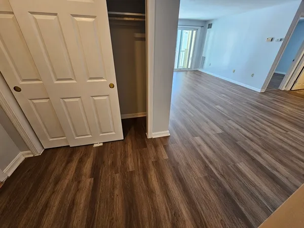 a view of a hallway with wooden floor