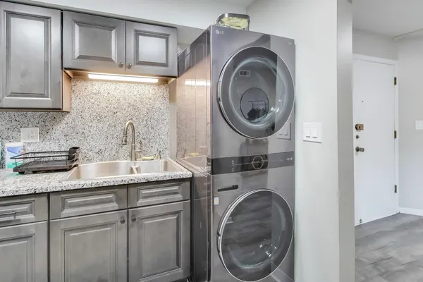 a bathroom with a sink and a washer dryer