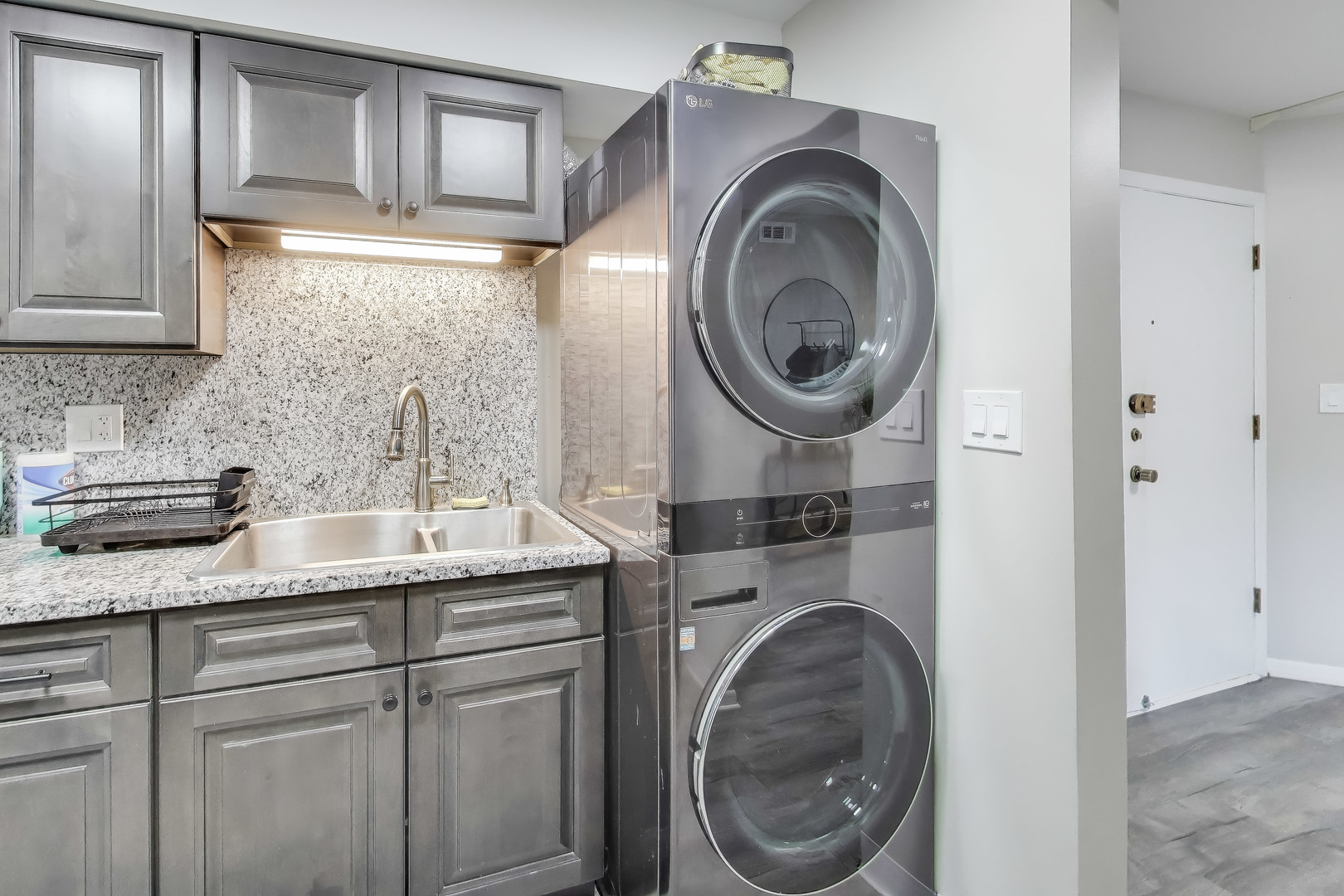 475 Shenstone Road, Unit 104 Riverside, IL 60546 - Photo 12 of 24 a bathroom with a sink and a washer dryer