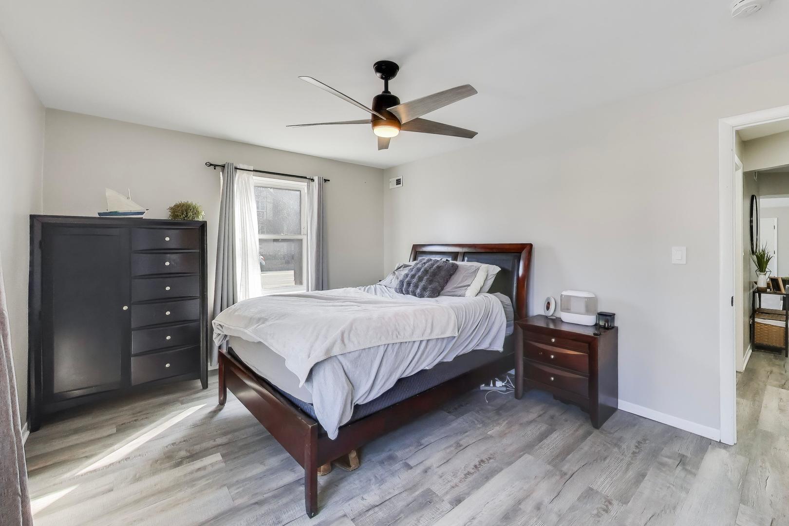 475 Shenstone Road, Unit 104 Riverside, IL 60546 - Photo 14 of 24 a bedroom with a bed and a chandelier