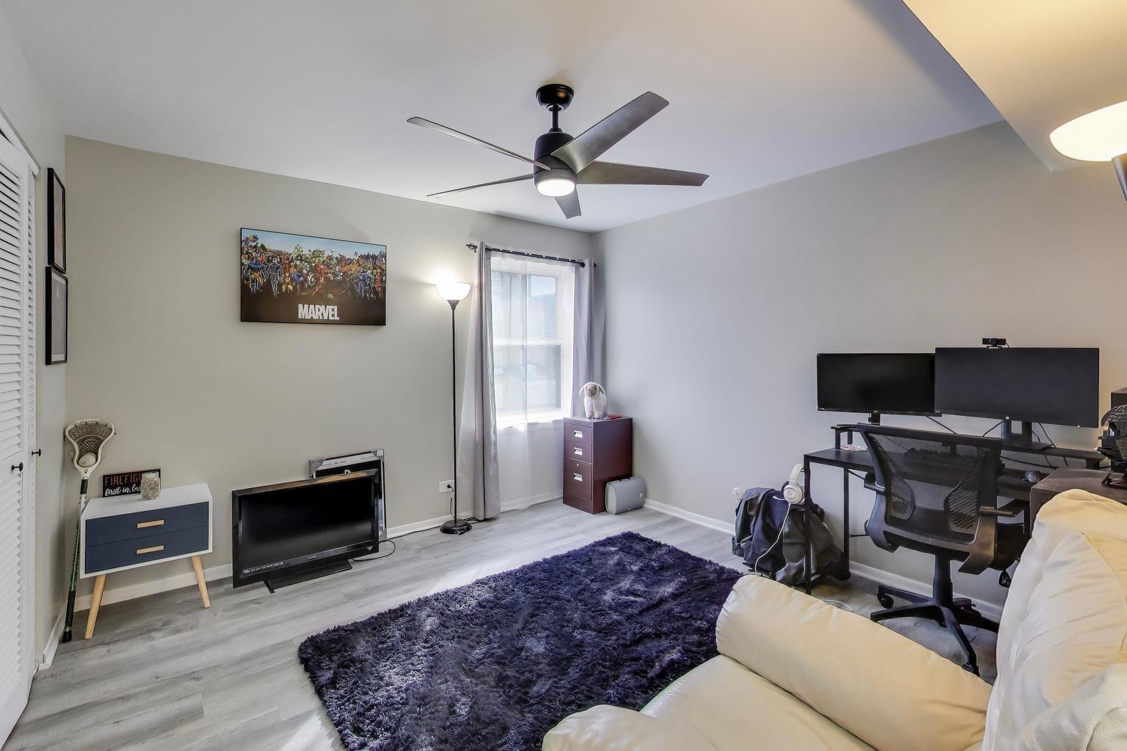 475 Shenstone Road, Unit 104 Riverside, IL 60546 - Photo 17 of 24 a living room with furniture and a flat screen tv