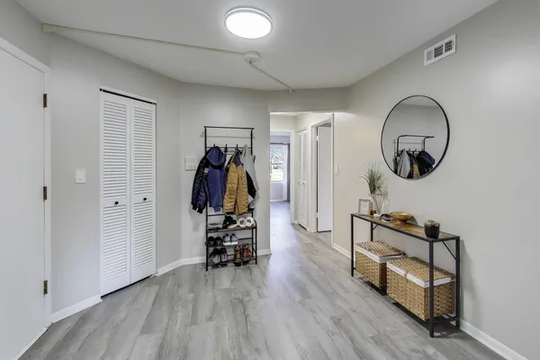 a view of a room with furniture and wooden floor