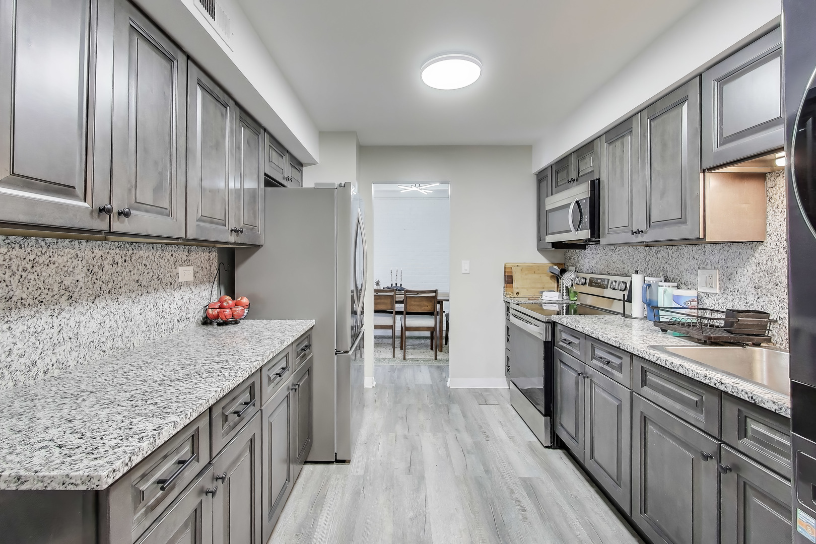 475 Shenstone Road, Unit 104 Riverside, IL 60546 - Photo 9 of 24 a kitchen with granite countertop lots of counter top space and stainless steel appliances