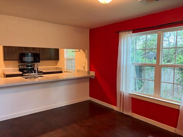 4744 Stokes Street Dallas, TX 75216 - Photo 5 of 20 a living room with stainless steel appliances kitchen island granite countertop a stove and a large window