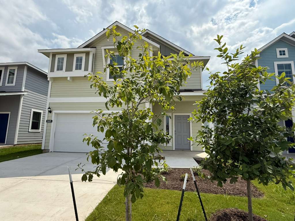 2605 Totley Road Manor, TX 78653 - Photo 2 of 40 a front view of a house with a yard