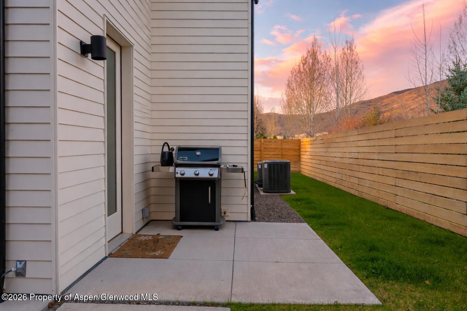 219 Juniper Court Basalt, CO 81621 - Photo 21 of 25 a view of a patio with table and chairs and couches with wooden fence